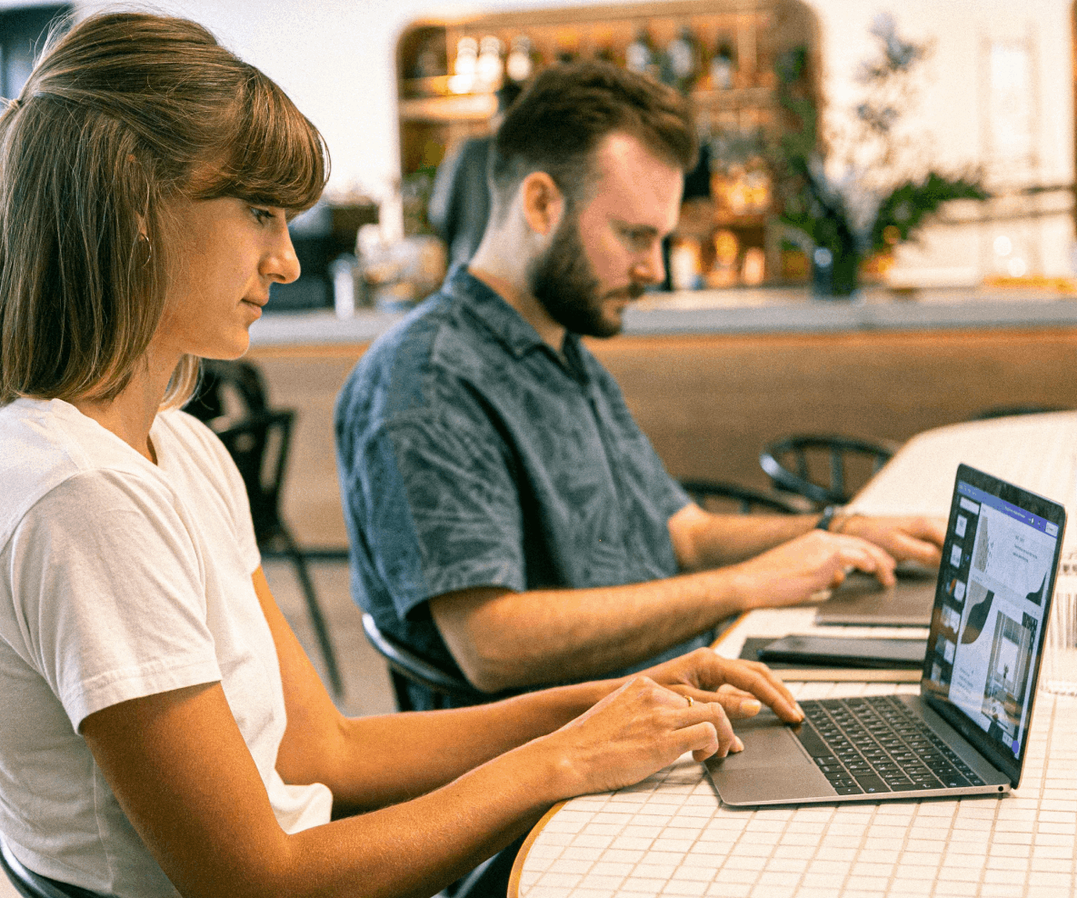 kobieta i mężczyzna przed laptopami