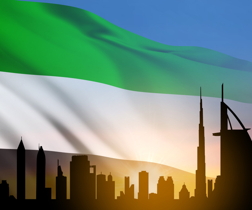 Flaga Zjednoczonych Emiratów Arabskich na tle miasta